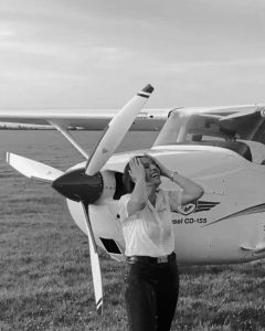 Captain Nadeen Qatameen Laughs Outside a Cessna Airplane